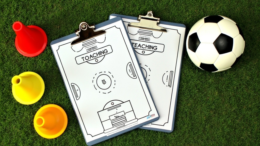 Stack of soccer coaching books and training equipment for youth